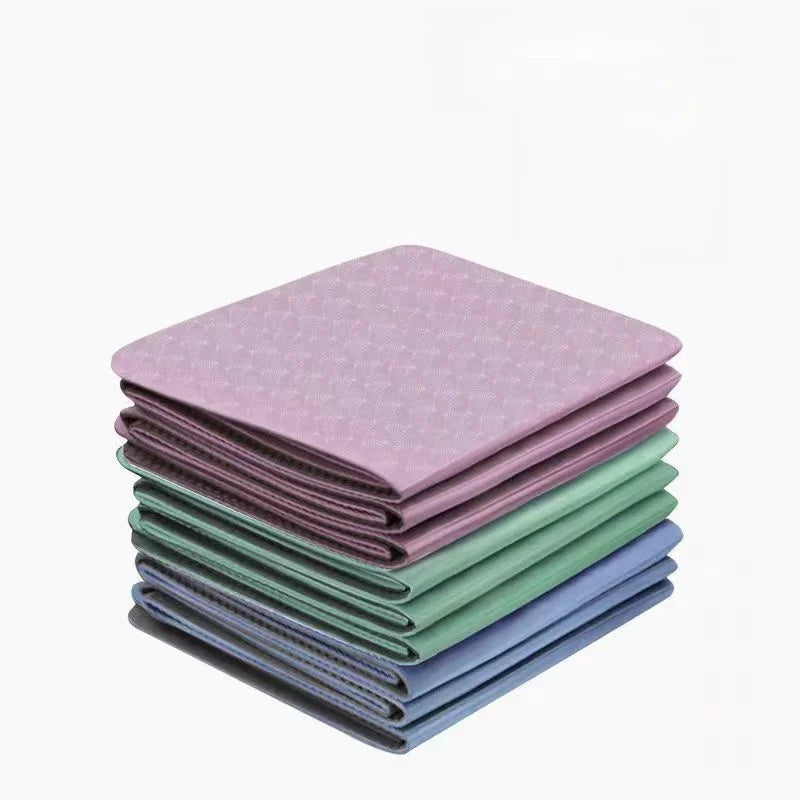 Foldable yoga mat stack in purple, green and blue with textured non-slip finish