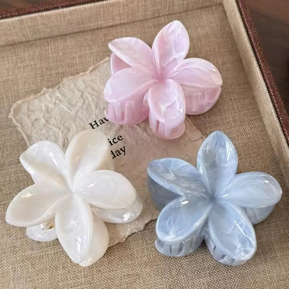 Hawaiian gradient flower hair claw clip set with white, pale pink, and light blue flowers