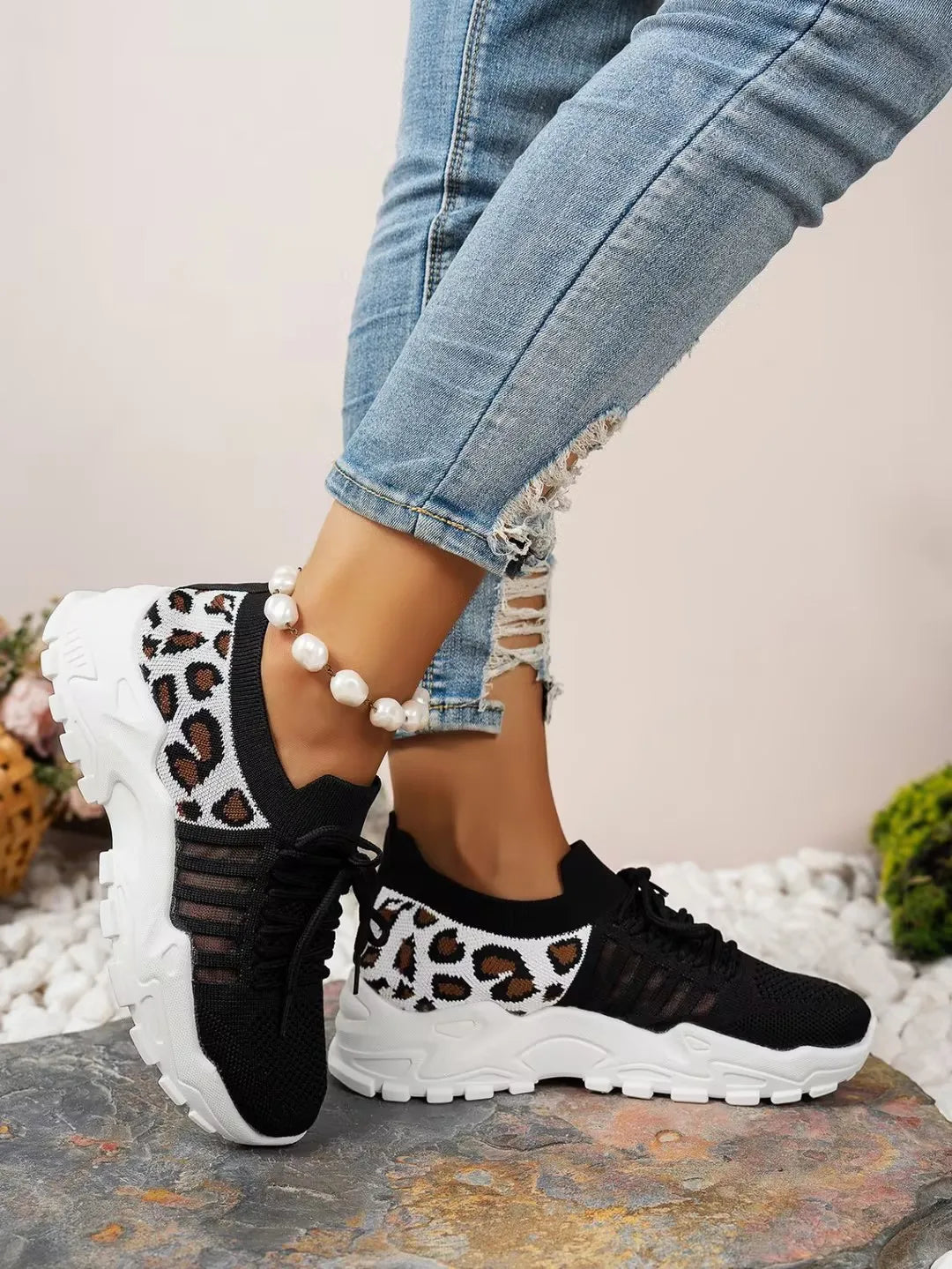 Women's leopard-print athletic sneakers with breathable black mesh upper and thick white sole