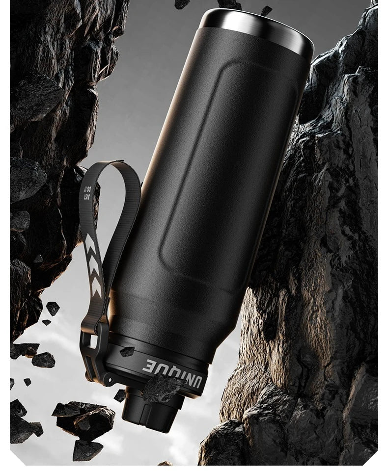 Insulated stainless steel sports bottle with flip lid and carrying strap, dark finish