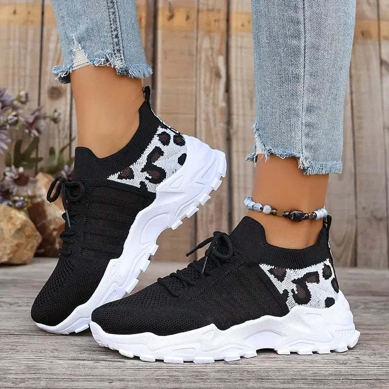 Women's leopard print athletic sneakers by Cedar & Moore, breathable knit upper and thick white sole