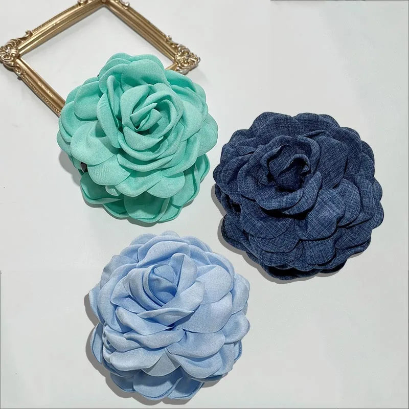 3-pack fabric rose hair claw clips in teal, navy, and light blue with claw bars