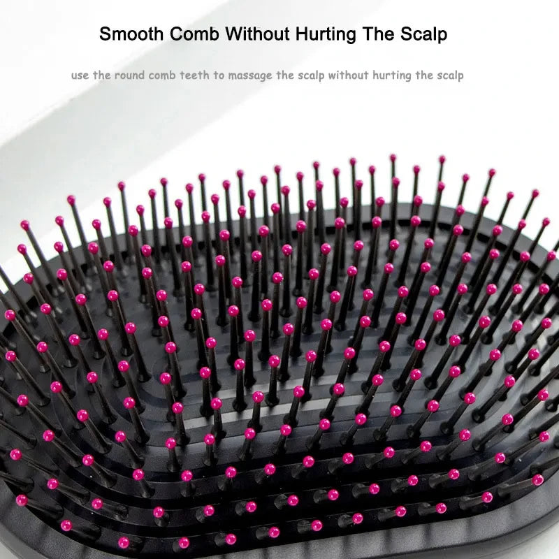 Round scalp massage hair comb head with pink-tipped pins on black base