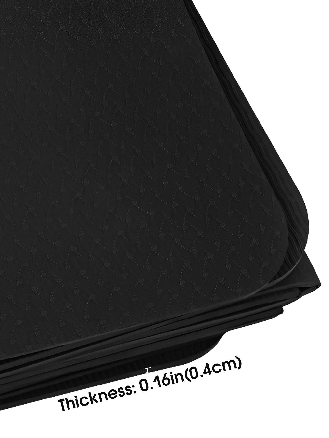 Black yoga mat edge with textured surface and folded layers.