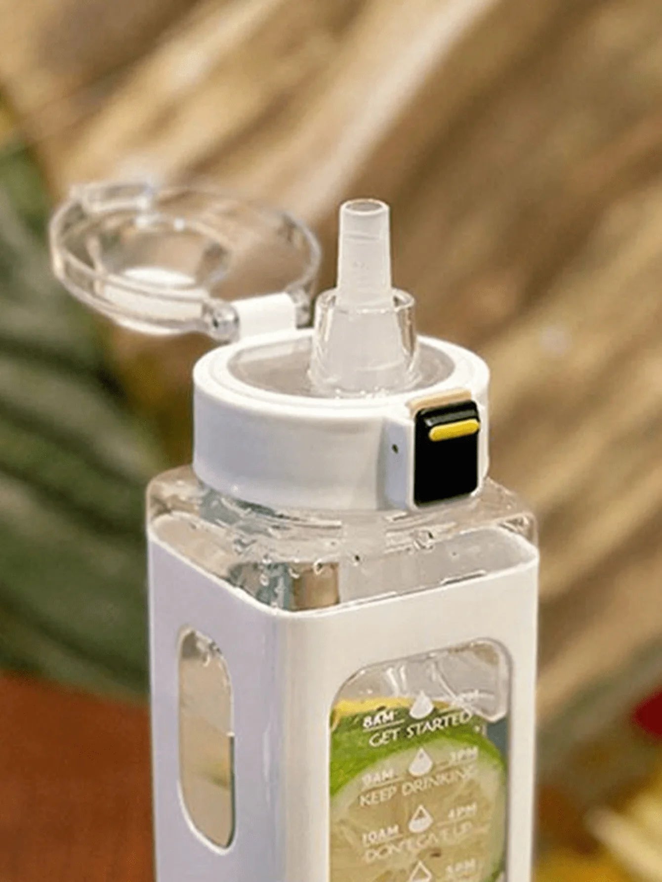 White sports water bottle with carry strap, straw lid, and front timetable panel