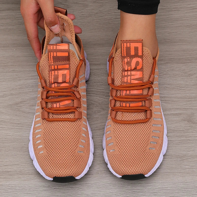 Lightweight running shoes in brown with white soles and lace-up straps