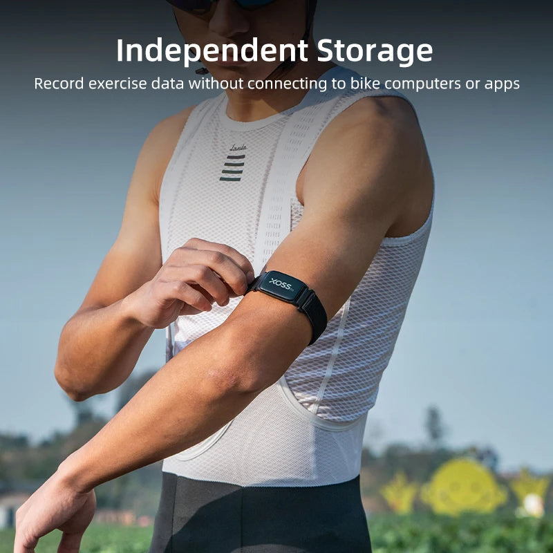 XOSS heart rate monitor armband on forearm, black strap with white XOSS logo.