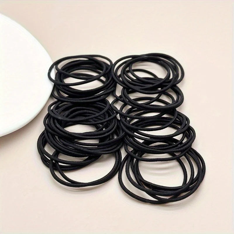 Black hair ties, assorted stack of coiled elastic loops