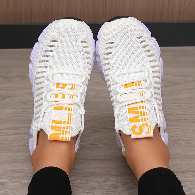 Lightweight running shoes in white with white soles and orange logo straps