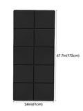 Black foldable yoga mat laid flat, segmented fold grid across the surface.