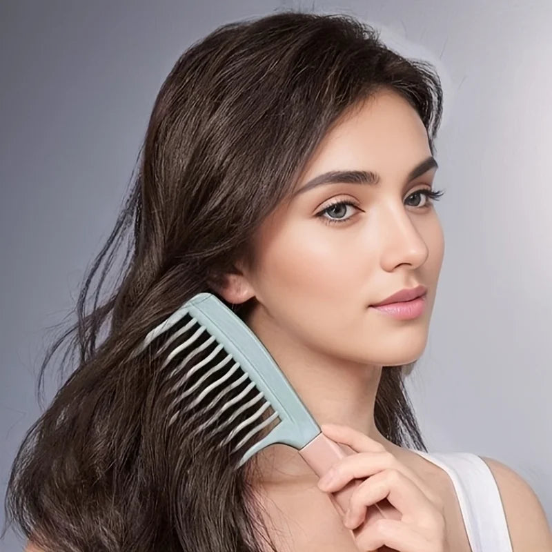Light blue wide-tooth detangling comb held near wavy hair, close-up on comb teeth