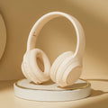 White over-ear wireless headphones with cushioned ear cups and headband, noise reduction