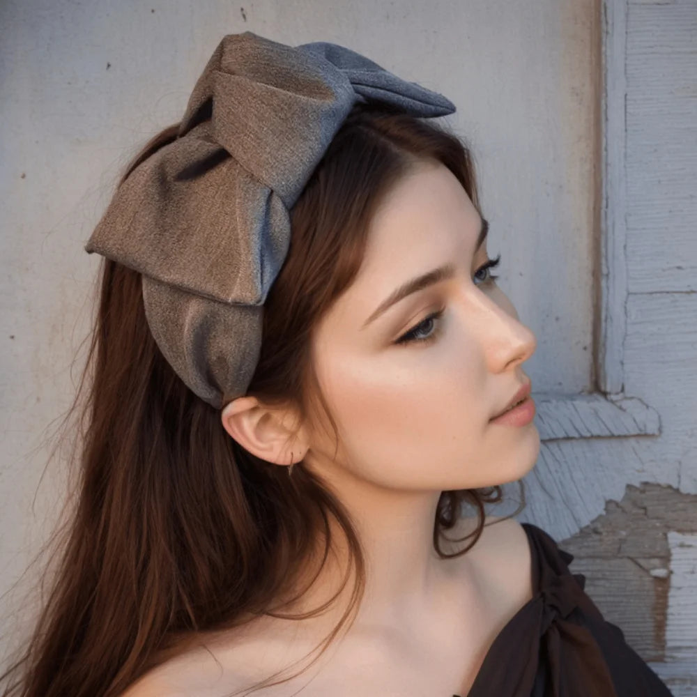 Grey wide bow headband with fabric knot, side view