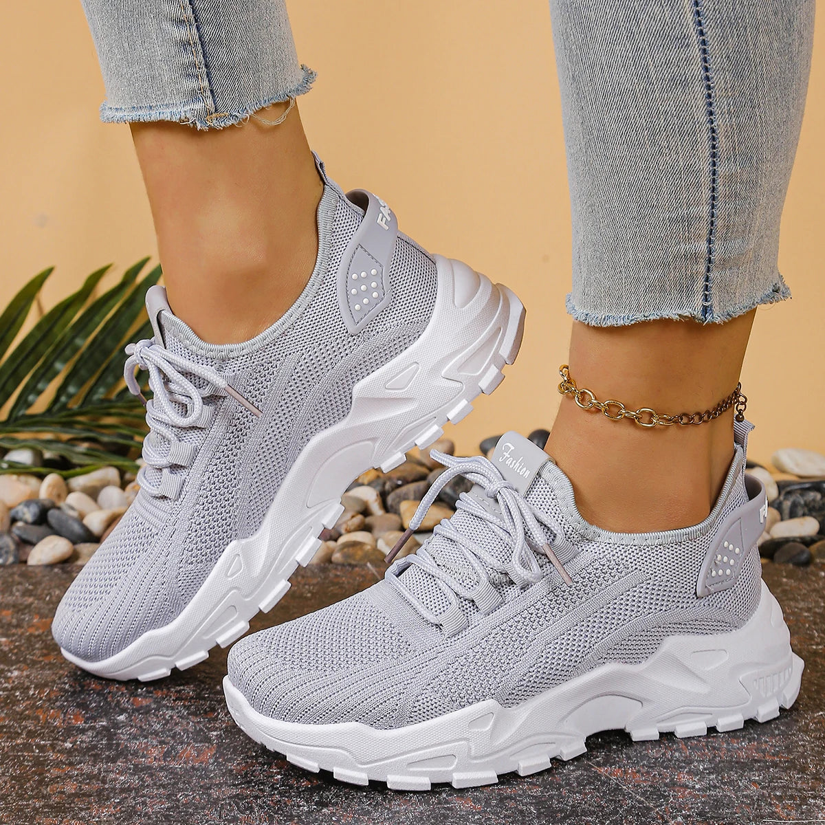 Women's breathable mesh athletic sneakers with thick white sole and gray knit upper