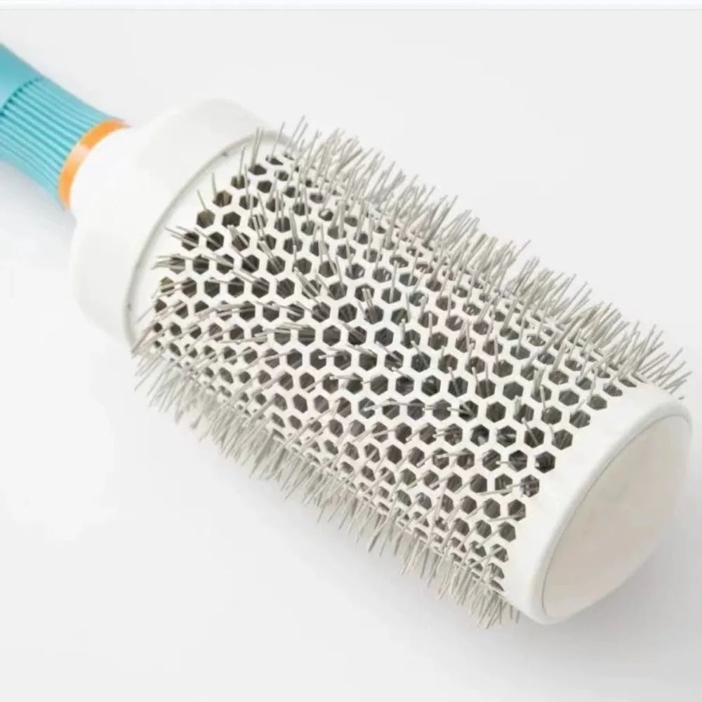 Close-up round barrel hair brush head with honeycomb metal structure and white bristles