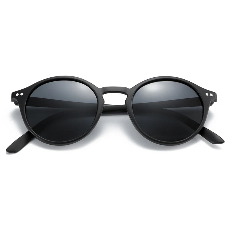 Round black sunglasses with dark lenses and slim curved temples