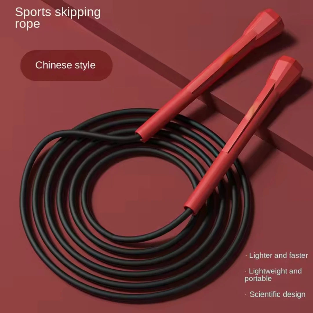 Black speed jump rope with red foam handles and coiled cable for training
