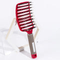 Boar bristle detangling hairbrush with red cushion pad and black textured handle
