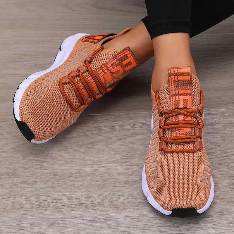 Women’s lightweight running shoes, tan knit upper with orange strap closure and white sole