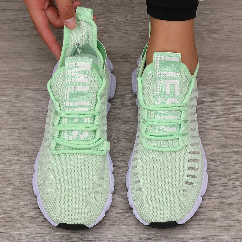 Lightweight running shoes in mint green with white soles and lace-up straps