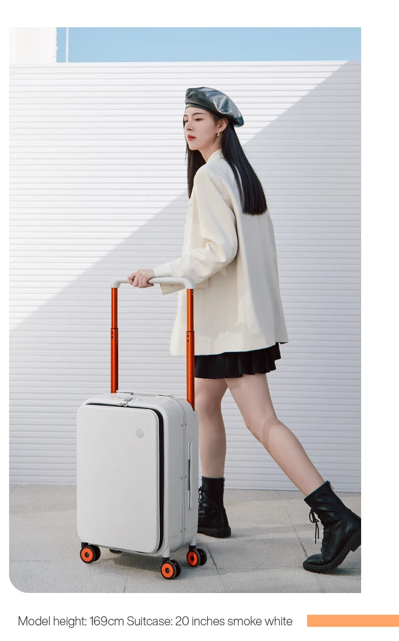 Smoke-white carry-on trolley suitcase with orange handle accents and four spinner wheels