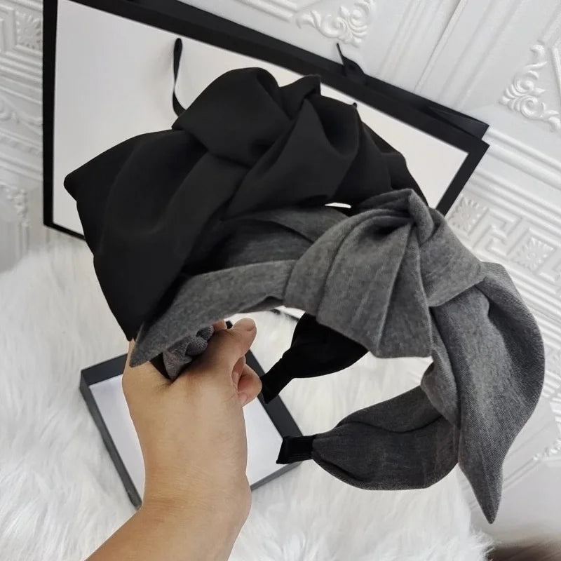 Bow headband with black fabric bow and grey tied knot