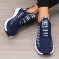 Women’s lightweight running shoes, navy knit upper with strap closure and white sole