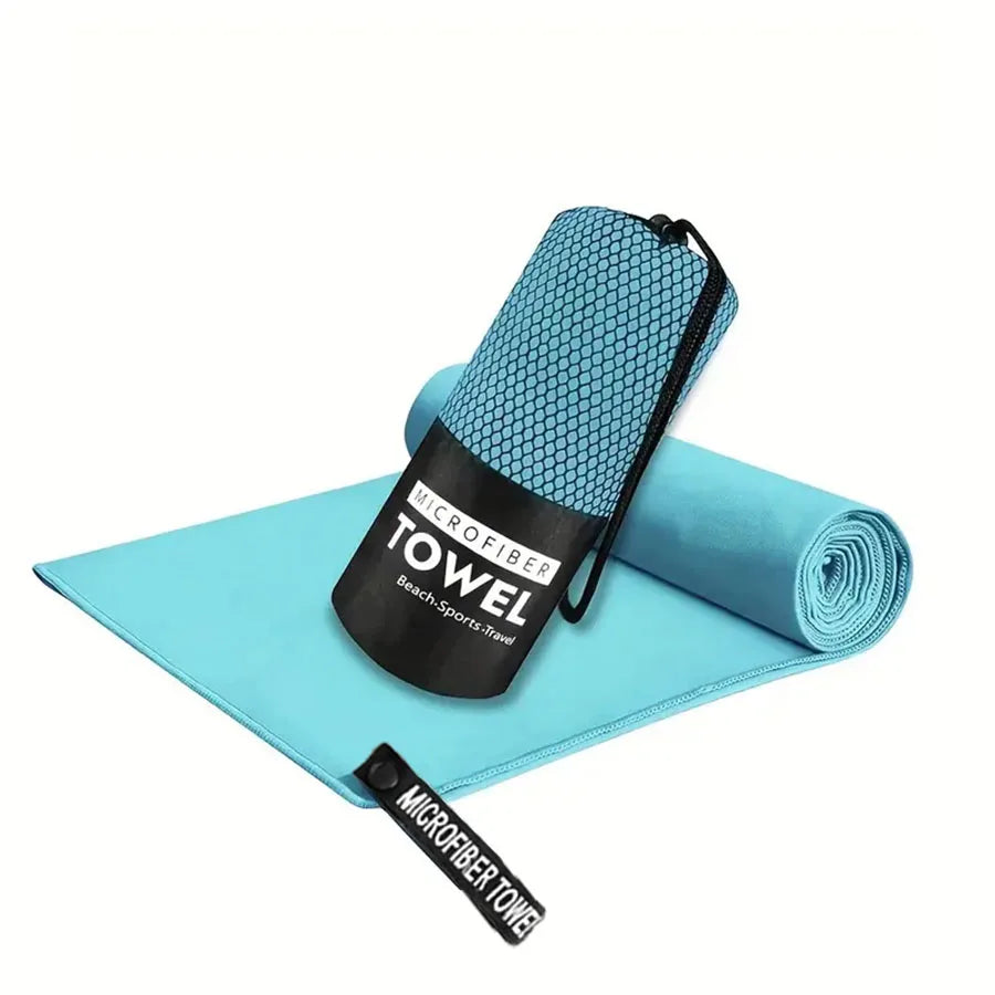 Microfiber yoga gym towel in turquoise blue, folded with rolled matching towel