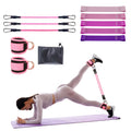Pink resistance band set with ankle cuffs and hip trainer, used during leg exercise