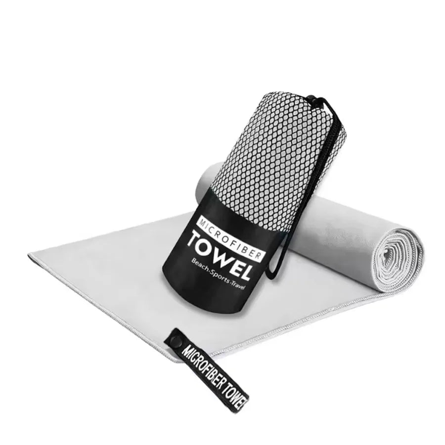 Microfiber yoga gym towel in light gray, folded with rolled matching towel