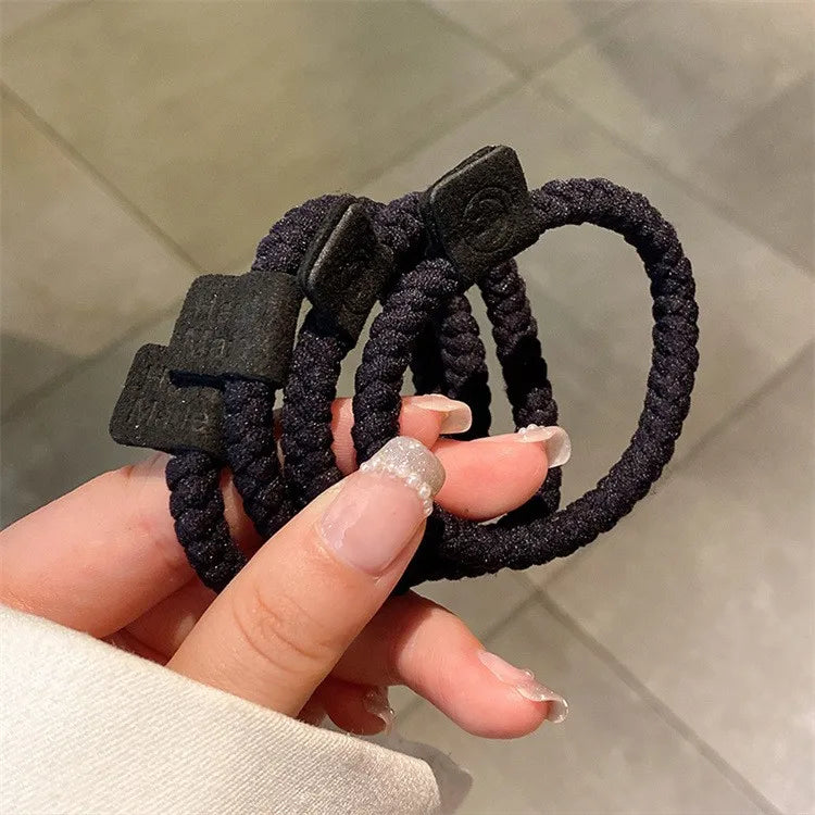 Hair scrunchie set with textured braided black elastic and square logo patches