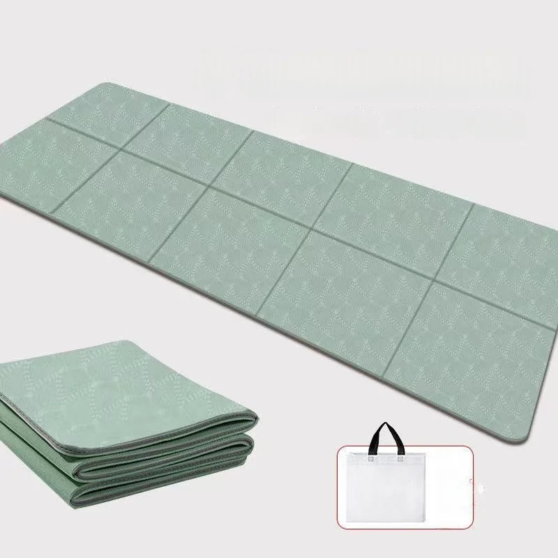 Foldable yoga mat in light green, ribbed non-slip texture, folded for portability
