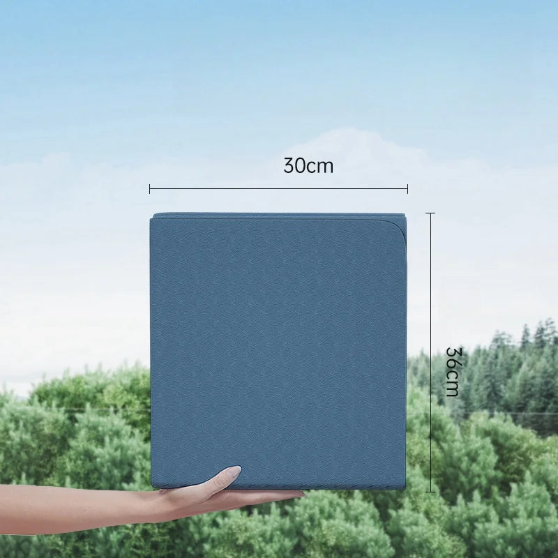 Foldable yoga mat in blue, held upright showing folded panels