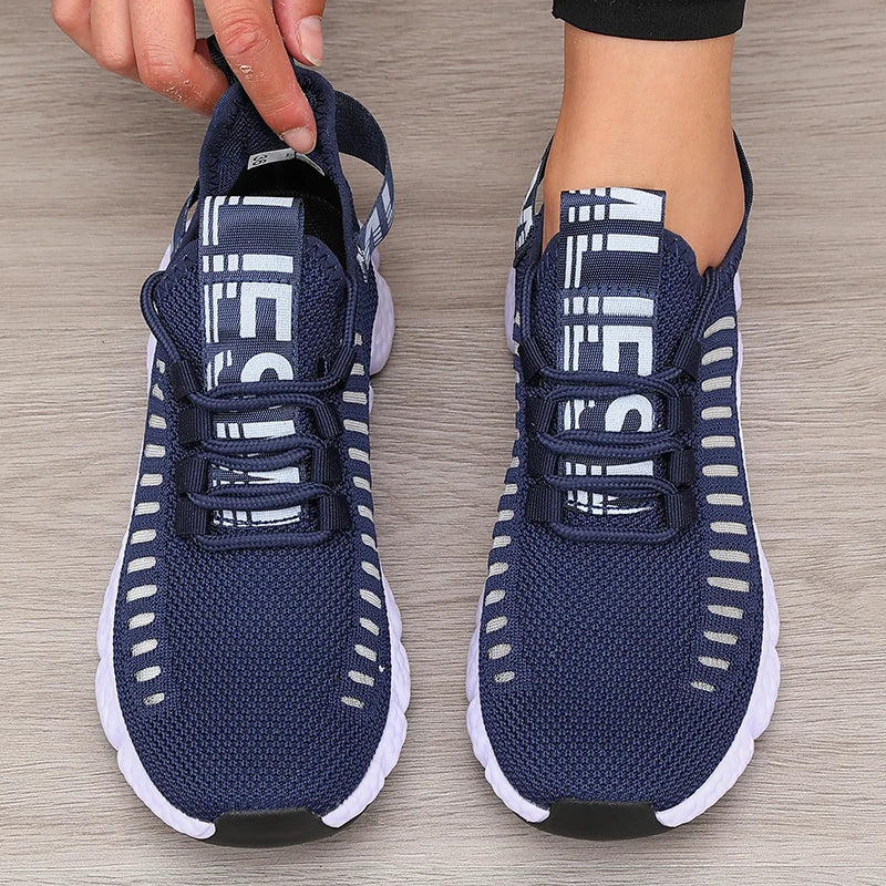 Lightweight running shoes in dark blue with white soles and lace-up straps