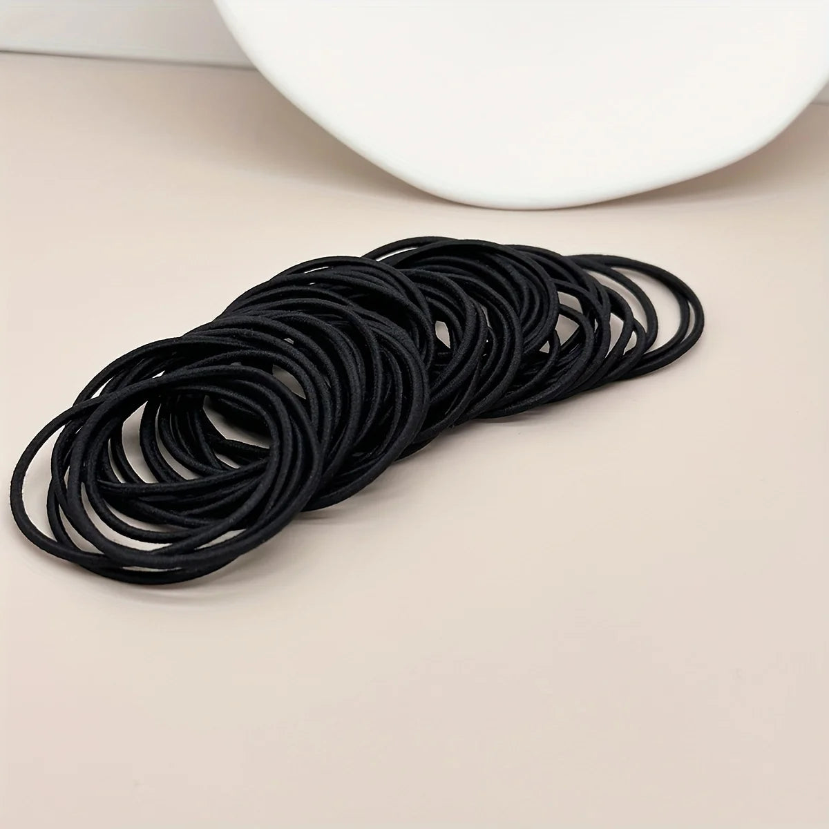 Black hair ties, row of coiled elastic loops
