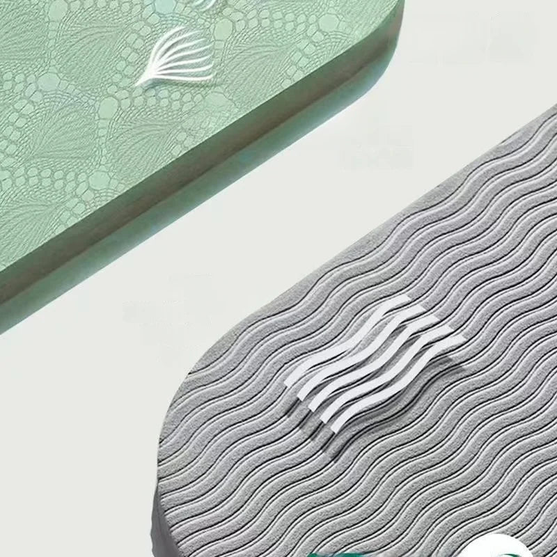 Foldable yoga mat in light green, close-up of embossed grip texture