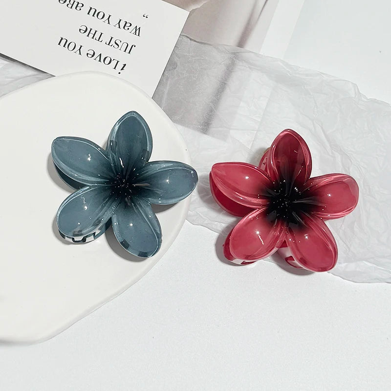 Blue and red translucent flower hair claw clips with starburst centers