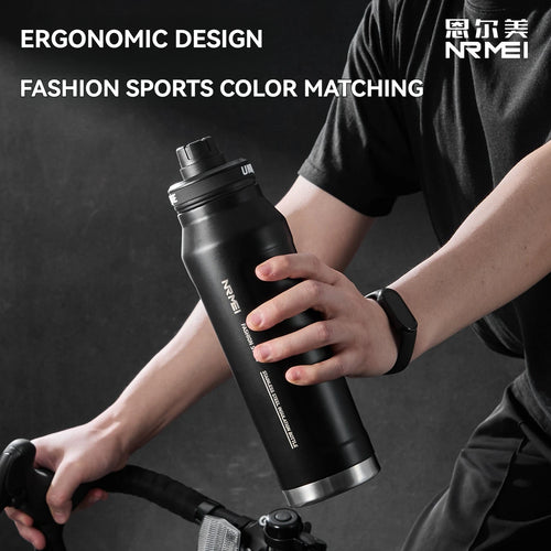 Black insulated stainless steel sports water bottle held in one hand