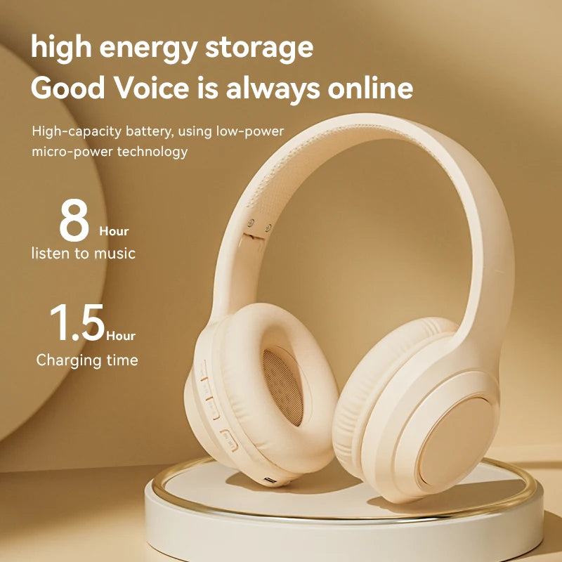 White over-ear wireless headphones on a charging stand with padded ear cushions.
