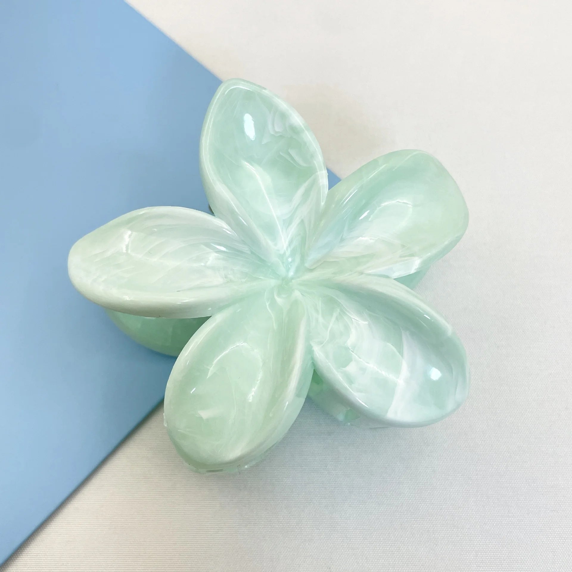 Mint green flower hair claw clip with translucent five-petal design and plastic barrette