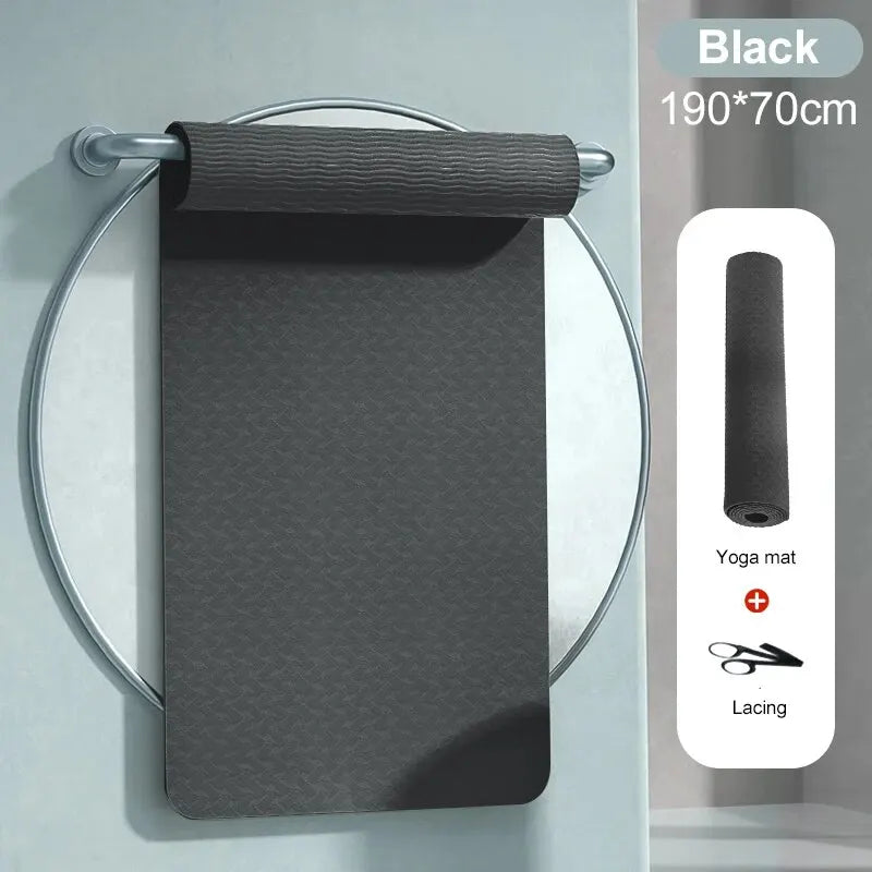 Black TPE yoga mat roll with strap accessories and textured non-slip surface