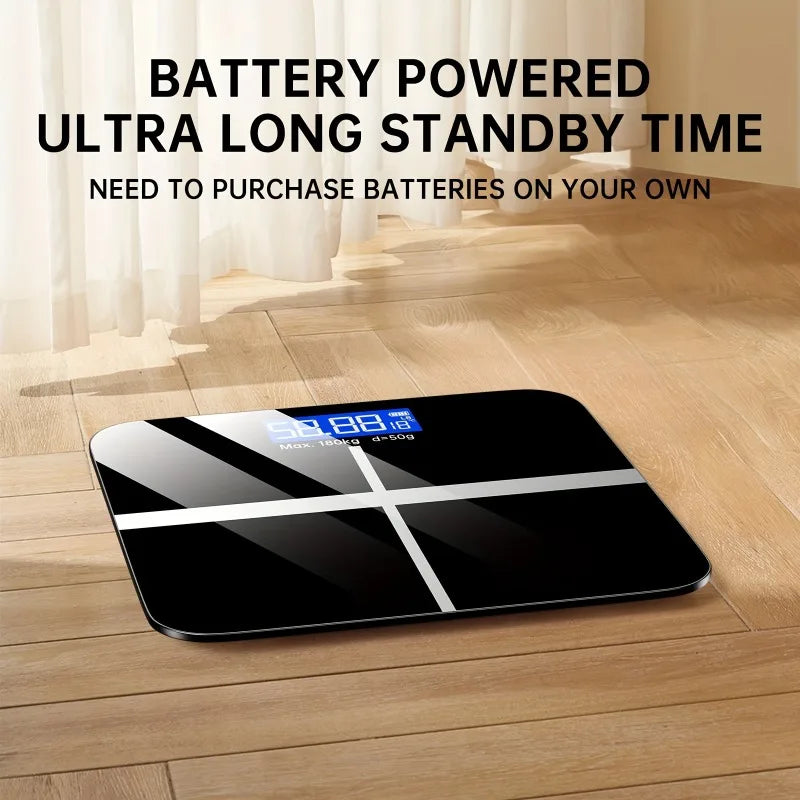 Digital bathroom scale with blue LED display on black glass surface on wood floor