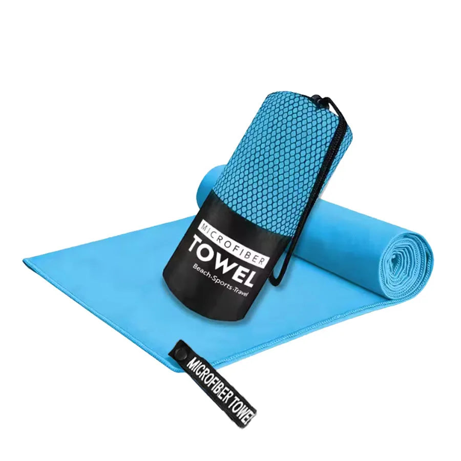 Microfiber yoga gym towel in light blue, folded with rolled matching towel