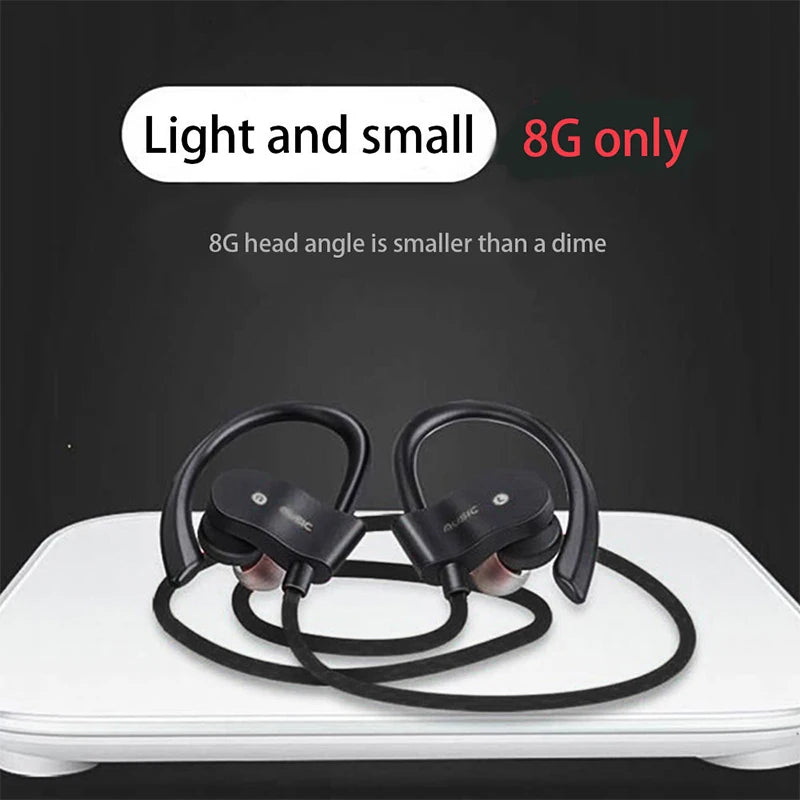 Black neckband sports earbuds with ear hooks and cable, earbuds laid on a surface