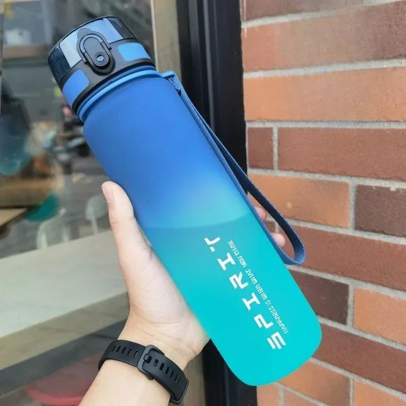 Sports water bottle with straw, blue gradient, flip-top lid and carry loop