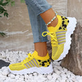 Women's leopard-print athletic sneakers in yellow with breathable knit upper and thick white sole.