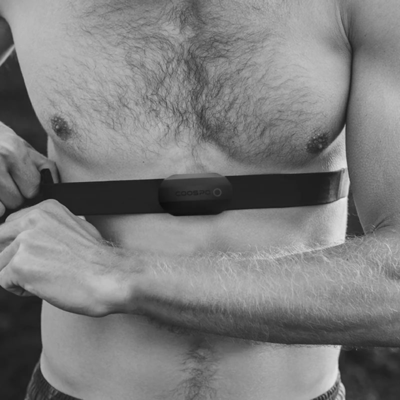 Heart rate monitor chest strap worn on bare skin with gray sensor pod