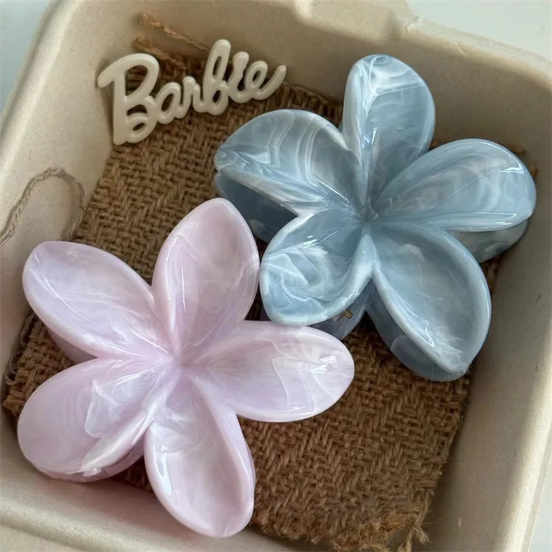 Hawaiian gradient flower hair claw clip set with light blue and pale pink blossoms