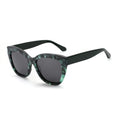 Cat-eye sunglasses with dark lenses and green-and-black patterned frames