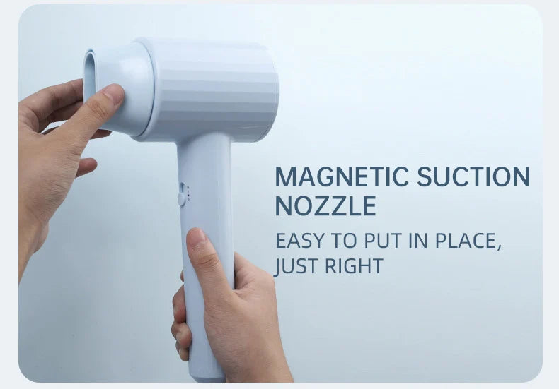 Light blue hair dryer with magnetic suction nozzle, shown with hands attaching